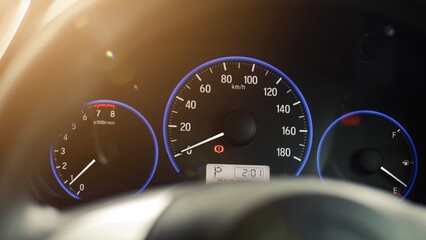 Car speedometer dashboard illuminated in the dark. Engine speed and rpm gauge. Automotive display.
