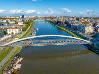 Krakow, Poland. Double suspension bridge under one arc: footbridge and bicycle bridge over Vistula...
