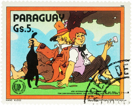 Tom Sawyer and Huckleberry Finn sitting under a tree