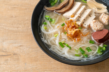 Vietnamese Rice Noodles Soup with Vietnamese Sausage served vegetables and crispy onion