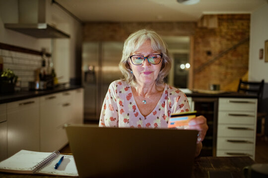 Senior woman online shopping on her laptop at home