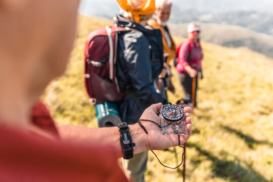 Guided by a compass, hikers prepare for their next adventure