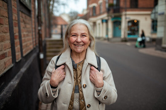 Portrait of a smiling senior woman in the city