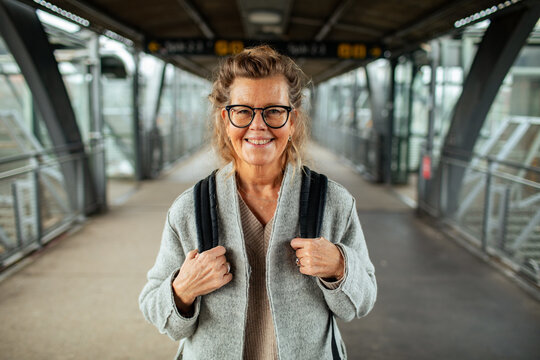 Portrait of a smiling elderly woman at the train station