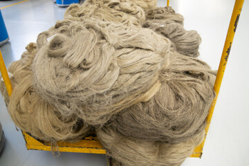 large bales with flax fibers for processing .Flax processing plant, fabric production. Flax is made...