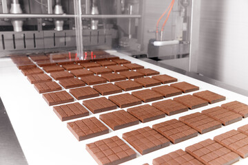 Chocolate sweets candy factory, sweet on conveyor automatic line, top view. Modern manufacturing...