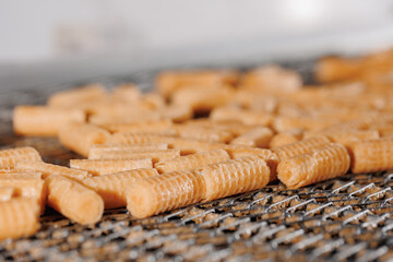 Rolls waffle on conveyor line for bake production. Concept modern bakery factory process