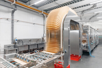 Automation conveyor line for production waffle cookie, modern bakery factory process. Concept food industry without people