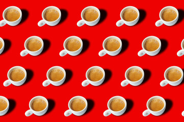 Many ceramic cups with hot aromatic coffee from above placed on bright colorful background. Coffee cups background pattern.