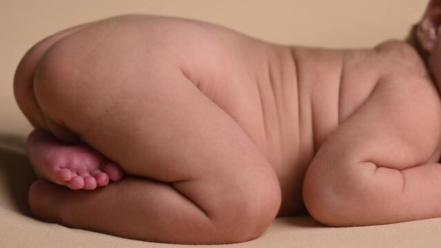 Sleeping newborn cute baby girl during first week of life. 4k slow motion120 fps raw video. Happy family concept. Small baby sleep in bed with small bear toy in hand and nipple
