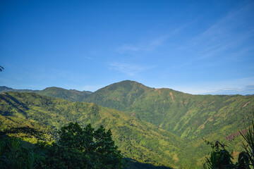 Green mountains with a blue sky
