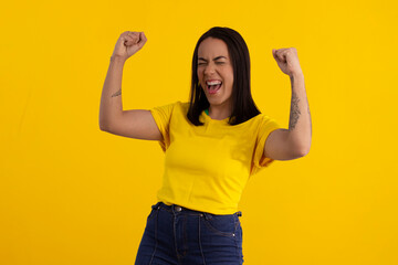 Young beautiful woman in shirt with the yellow color of Brazil in studio photo with various expressions of feelings