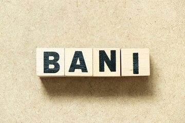 Alphabet letter block in word BANI (Brittle, Anxious, Non-linear and Incomprehensible) on wood...