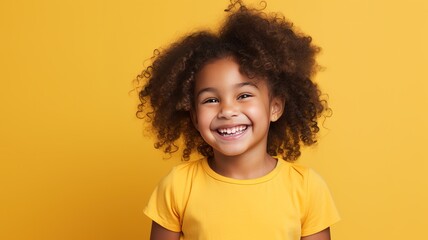 funny curly cute little smiling african american child school girl with a perfect smile and white teeth wearing yellow t-shirt looking at camera on yellow background with copy space. ai - obrazy, fototapety, plakaty