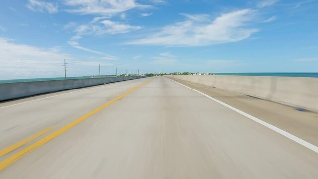 POV Driving a car on famous US Route 1, Overseas Highway Bridge in Florida. Sunny day with blue sky