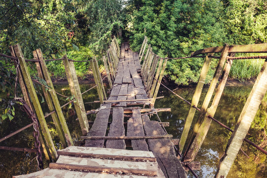 Old destroyed wooden bridge on the river