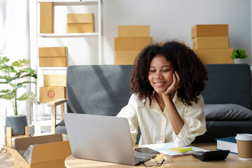 African American businesswoman sitting at the desk in front of the laptop and thinking.