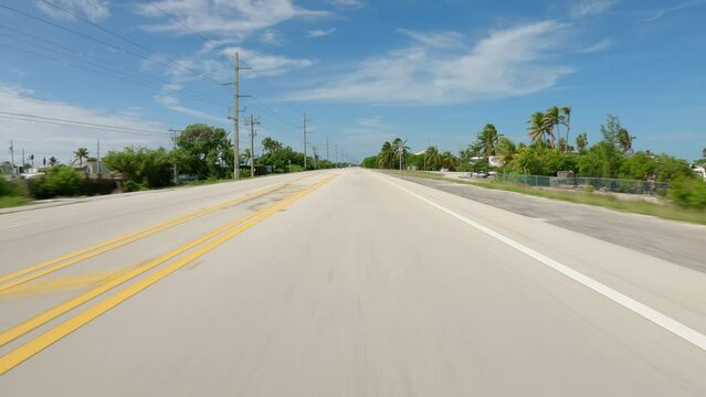 POV Driving a car on famous US Route 1, sunny day in Florida Keys near Marathon