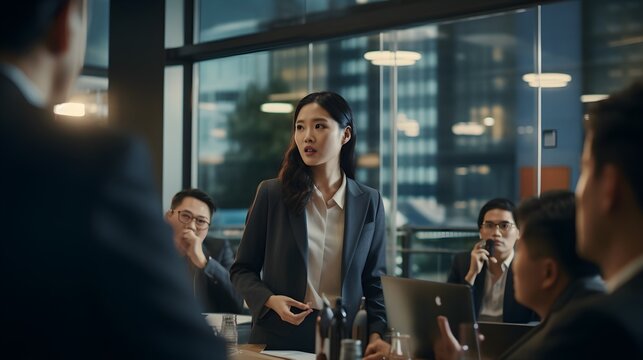 Women leaders, a determined woman leading a boardroom meeting, emphasizing her authority and the diverse team supporting her vision.