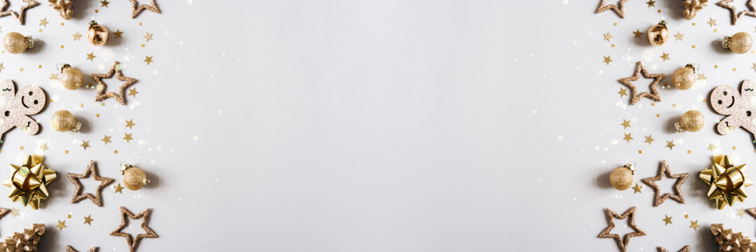 Christmas or New year banner with various golden decorations on grey background