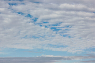 A blue sky with white clouds is a classic and serene sight