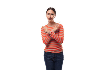 A 30-year-old slender European woman dressed in a casual orange sweater crossed her arms in front...