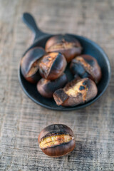 roasted chestnuts on wooden background