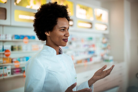 A dedicated pharmacist assists customers in a well-stocked pharmacy