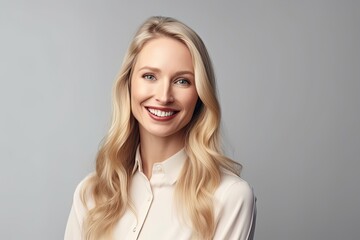 profile view of american business blond  woman smiling against dark background, copy space