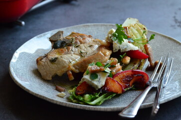 food background, served pork steak on a plate with fruit and tossed salad