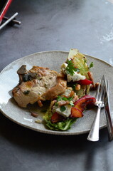 food background, served pork steak on a plate with fruit and tossed salad