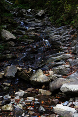 rocky small waterfall in the mountains. big stones. stream and stones