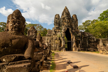 One of the access gates to the temples of Angkor, guarded by warrior figures and giant faces...