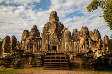 Main entrance and view of Bayon temple with its half-collapsed columns, near Angkor Cambodia, at sunset.