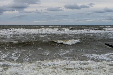 seashore on a cloudy cloudy day, strong storm waves