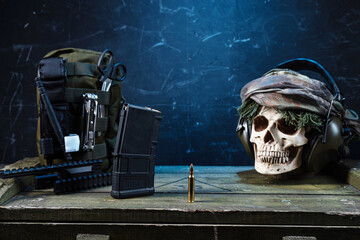 Military composition with a bullet and a skull. Machine gun bullet and military equipment. Skull...