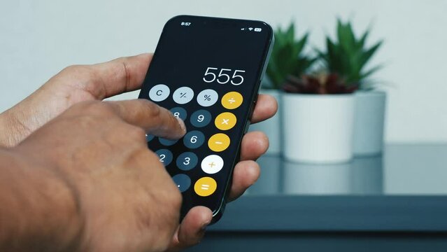 close up of using calculator in mobile phone, random calculation
