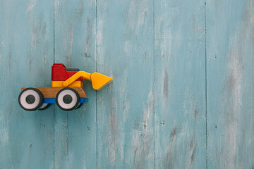 Toy tractor on vintage wooden surface with copyspace - Powered by Adobe