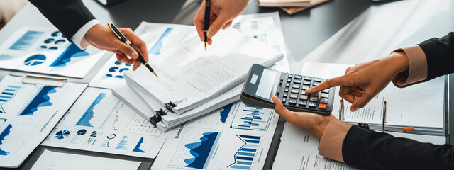 Auditor and accountant team working in office, analyze financial data and accounting record with calculator. Accounting company provide finance and taxation planning for profitable cash flow. Insight - obrazy, fototapety, plakaty