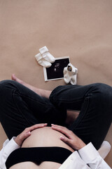 young pregnant woman. woman with an ultrasound photo in her hands.