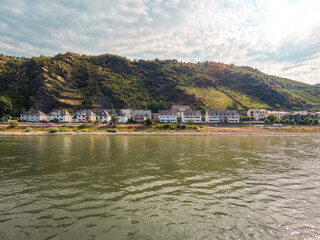 Fototapeta premium Traveling along the Rhine River with scenic views of the quaint village of Kaub, Germany. View into land of European style architecture. Kaub is a small German village in Rhineland-Palatinate.