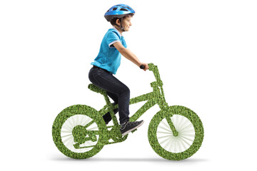 Boy with a helmet riding a green eco bicycle - obrazy, fototapety, plakaty