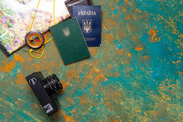 Documents, map and camera. Verification of documents. Migration Service. Passport and military ID. View from above. - obrazy, fototapety, plakaty