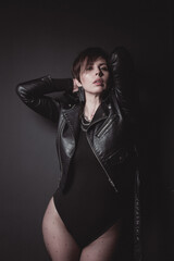 portrait of a sexy woman in leather jacket and pantyhose