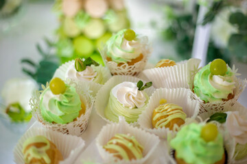 cakes decorated with cream and grapes in paper rosettes