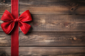 Rotes Band mit Schleife auf rustikalem Holzhintergrund. Grußkarte für Weihnachten, Geburtstag, Valentin oder Jubiläum mit Platz für Text - obrazy, fototapety, plakaty
