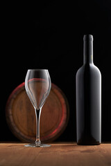 red wine bottle and glass barrel in bacground copy space