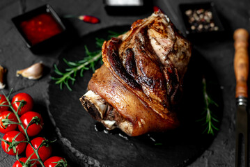 pork knuckle baked in the oven on a stone background