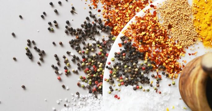 Spices, herbs and powder on table top in kitchen for cooking, food or seasoning collection with color. Top View, Curry and tumeric or salt with colorful seeds, cumin and masala on arrangement board