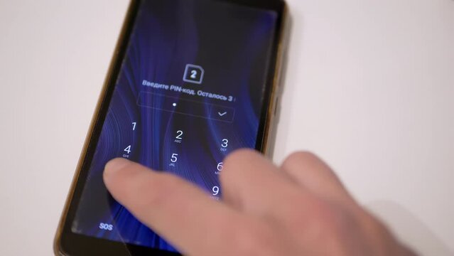 Close up, Woman Enters Digital PIN code on Smartphone Screen to Unlock Phone. Selective focus. Login is successful. Phone is locked. Security password is enabled on the mobile phone screen. Finger.